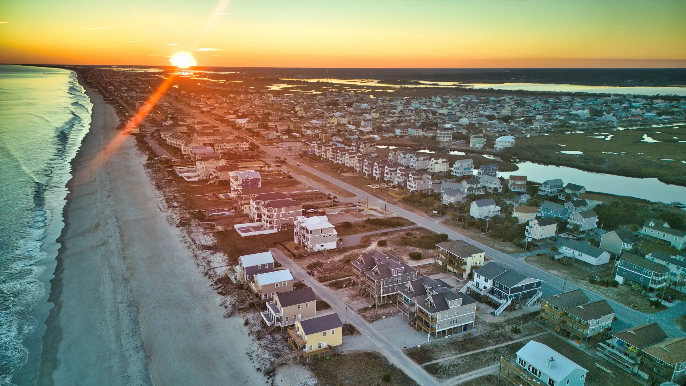 Aerial view of a coastal North Carolina beach community at sunset